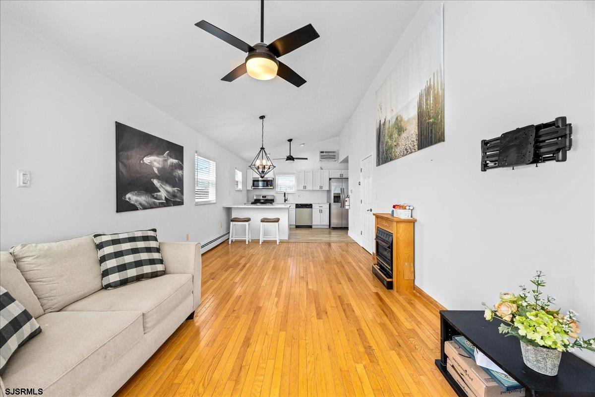 211 2nd Street South, Unit 2 Brigantine, NJ 08203 - Photo 8 of 35 a living room with furniture and a flat screen tv