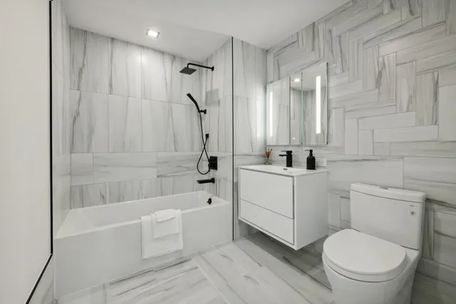 a view of en suite bathroom with a tub and shower