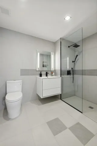 a bedroom with two beds and a large window