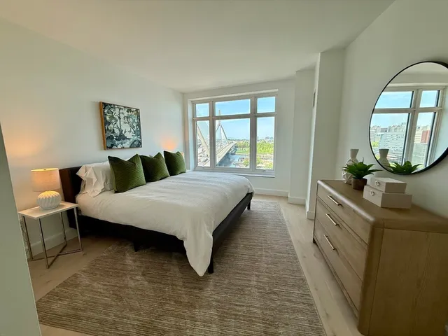 a spacious bedroom with a bed and window