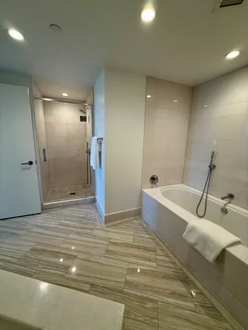 a bathroom with a bathtub and shower