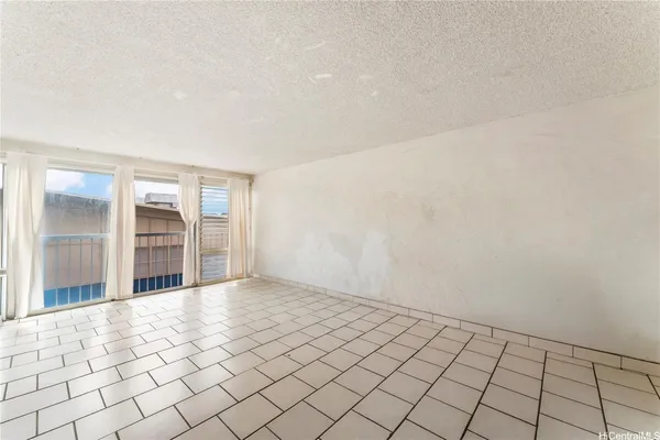 a view of a livingroom with an empty space and window