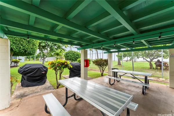 a view of a patio with table and chairs potted plants with wooden floor