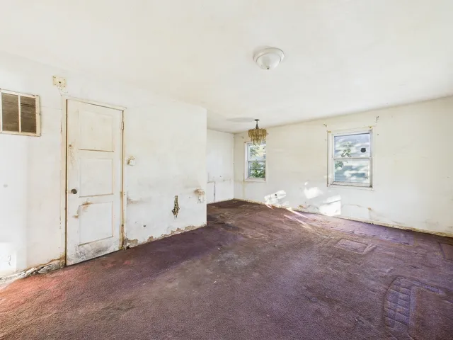a view of a livingroom with a kitchen and a window