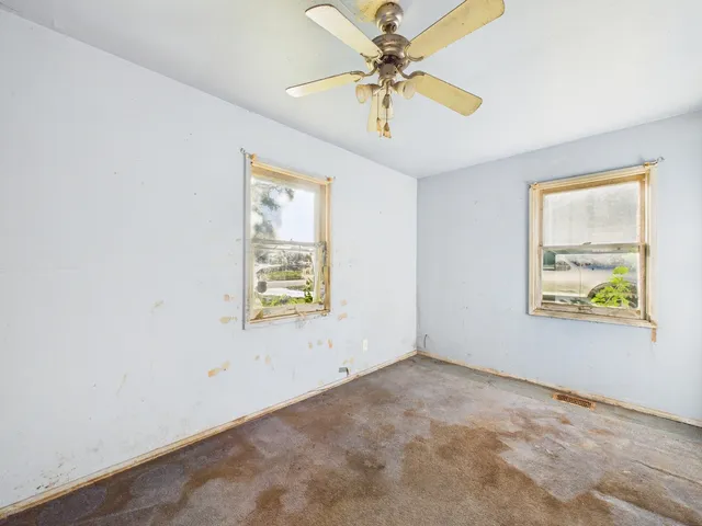 a view of a livingroom with a ceiling fan and window