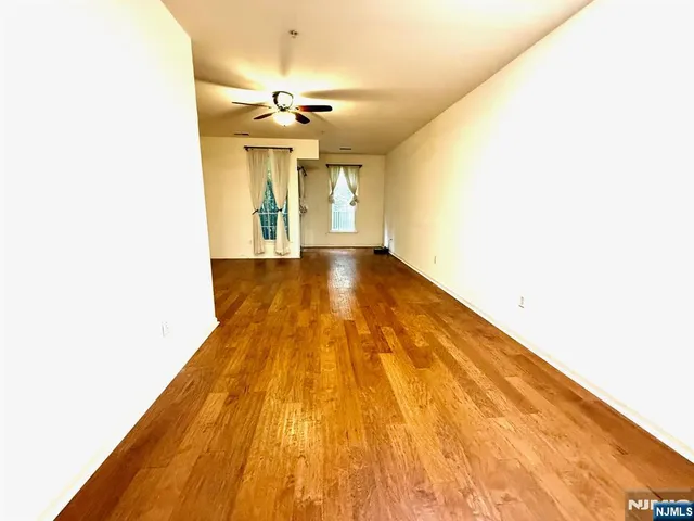 a view of a room with wooden floor