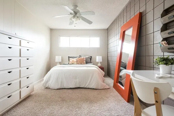 a bedroom with a bed and a window