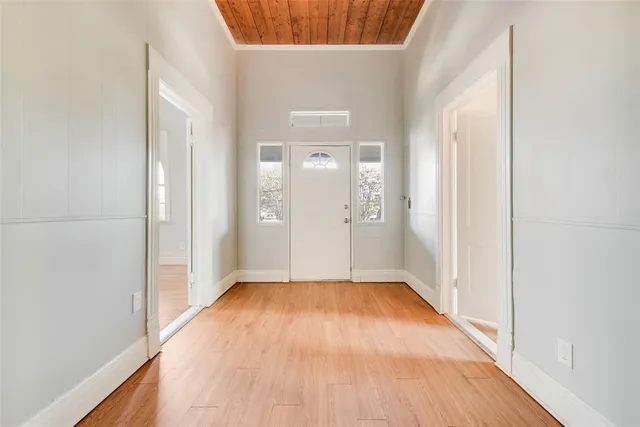 a view of a hallway with wooden floor