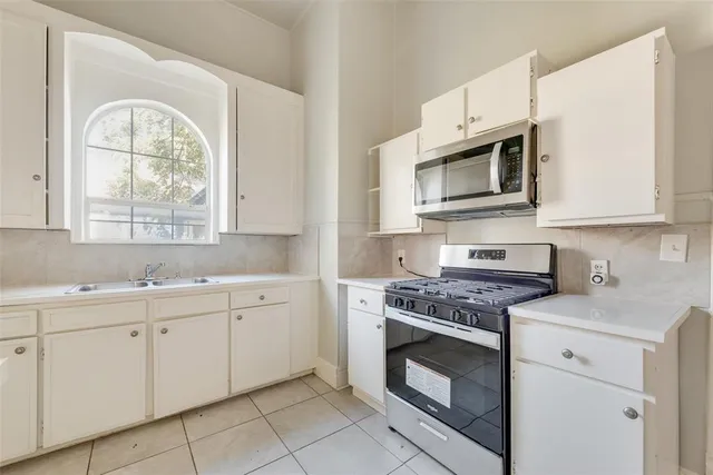 a kitchen with cabinets appliances and a sink