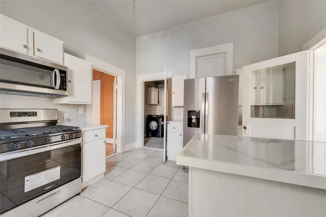 a kitchen with stainless steel appliances granite countertop a refrigerator stove and sink