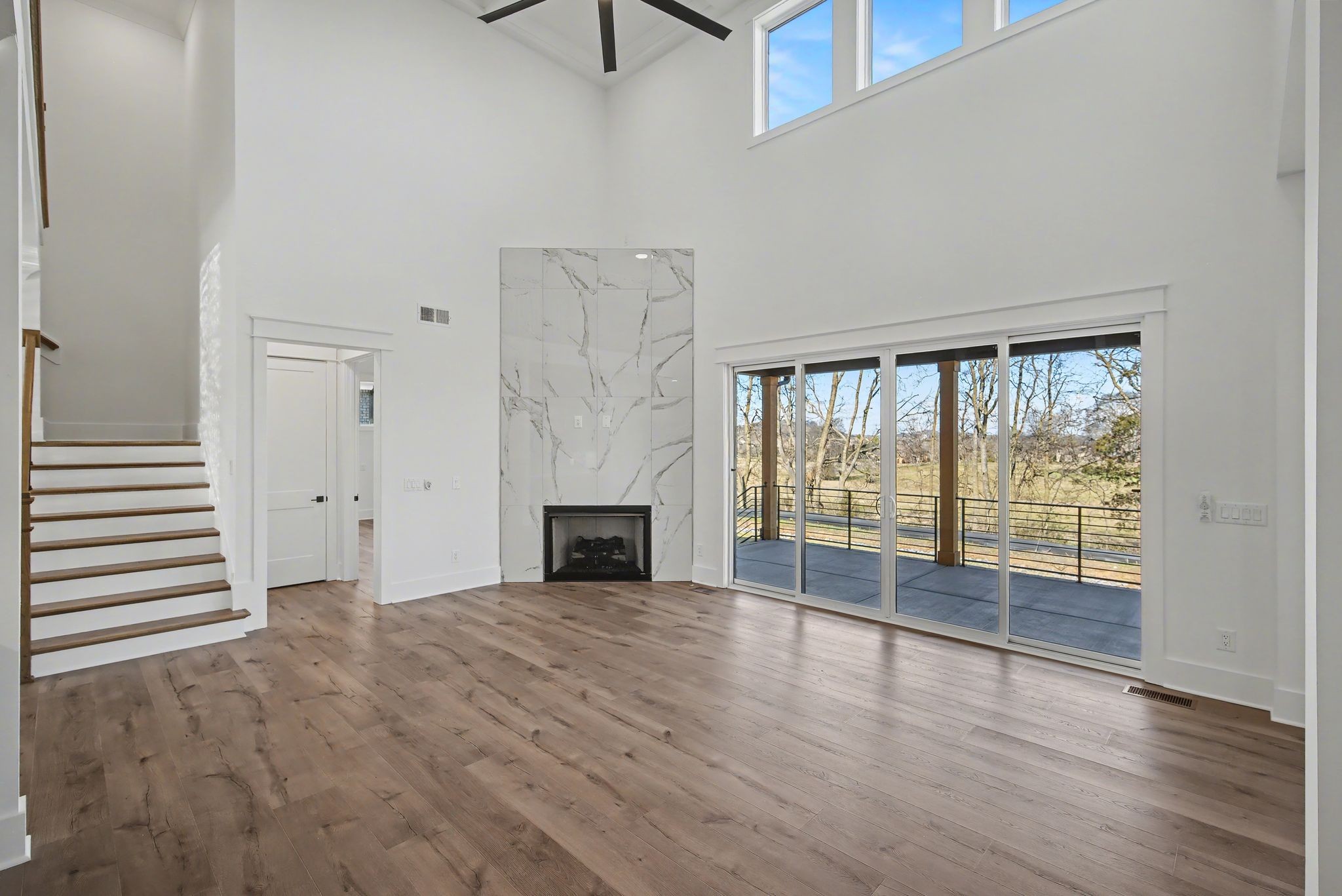 225 Bellsford Road Gallatin, TN 37066 - Photo 12 of 55 a view of an empty room with wooden floor and a window