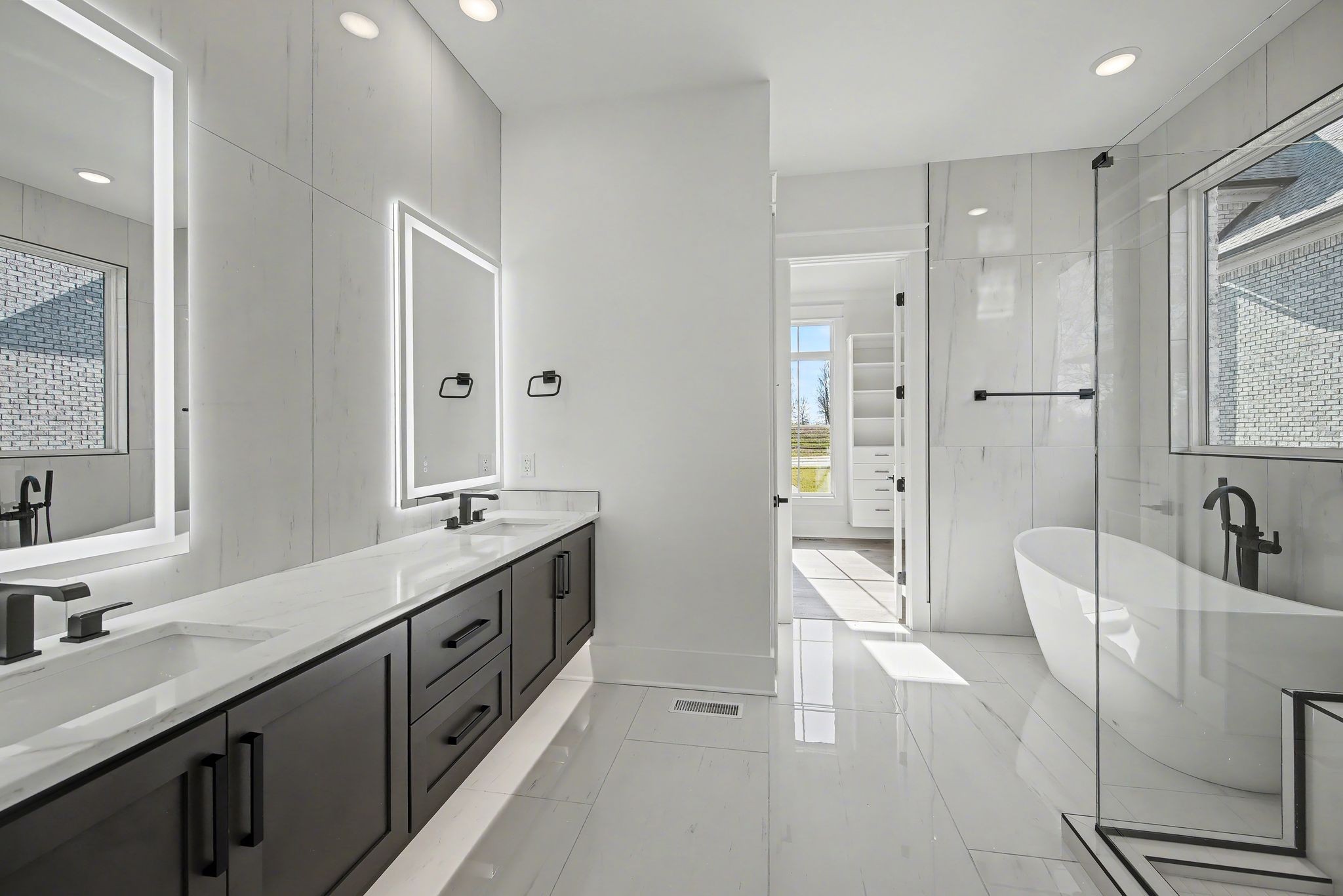 225 Bellsford Road Gallatin, TN 37066 - Photo 33 of 55 a spacious bathroom with a double vanity sink a large mirror and a bathtub
