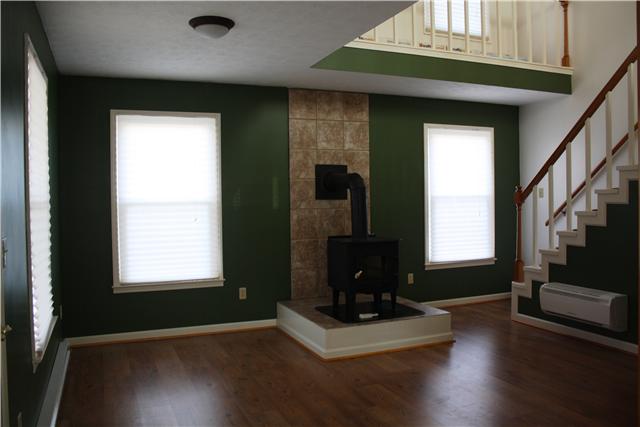2372 Jarrell Ridge Road Clarksville, TN 37043 - Photo 7 of 18 The living room as seen from the front door. Custom paint colors and this wood burning stove make this house so cozy!!! Lots of windows too for plenty of natural light.