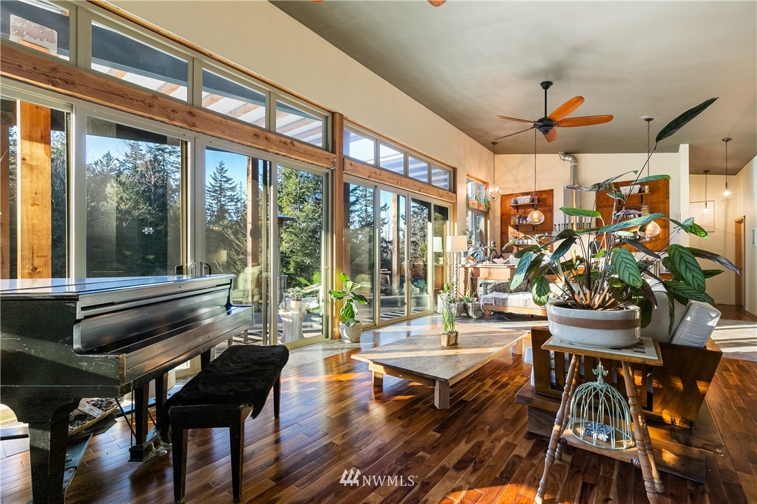 128 Hiline Road Bellingham, WA 98229 - Photo 13 of 27 a living room with patio furniture and a floor to ceiling window