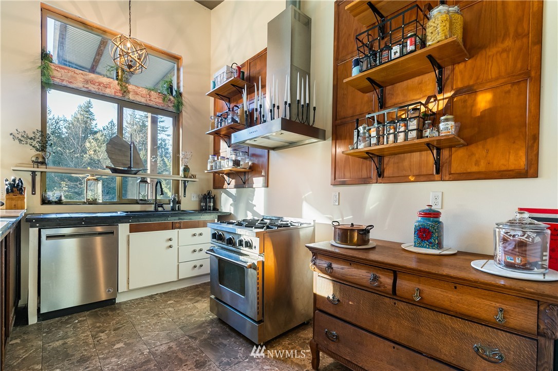 128 Hiline Road Bellingham, WA 98229 - Photo 18 of 27 a kitchen with stainless steel appliances granite countertop a sink a stove and wooden floors