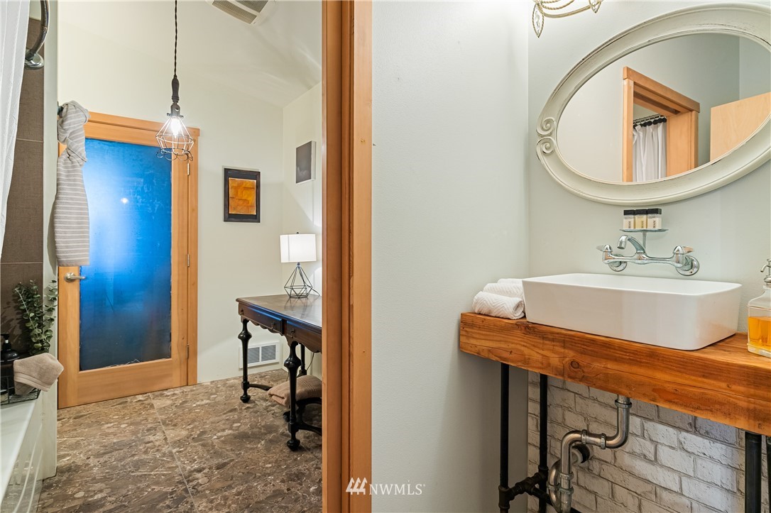 128 Hiline Road Bellingham, WA 98229 - Photo 24 of 27 a bathroom with a sink a mirror and a toilet