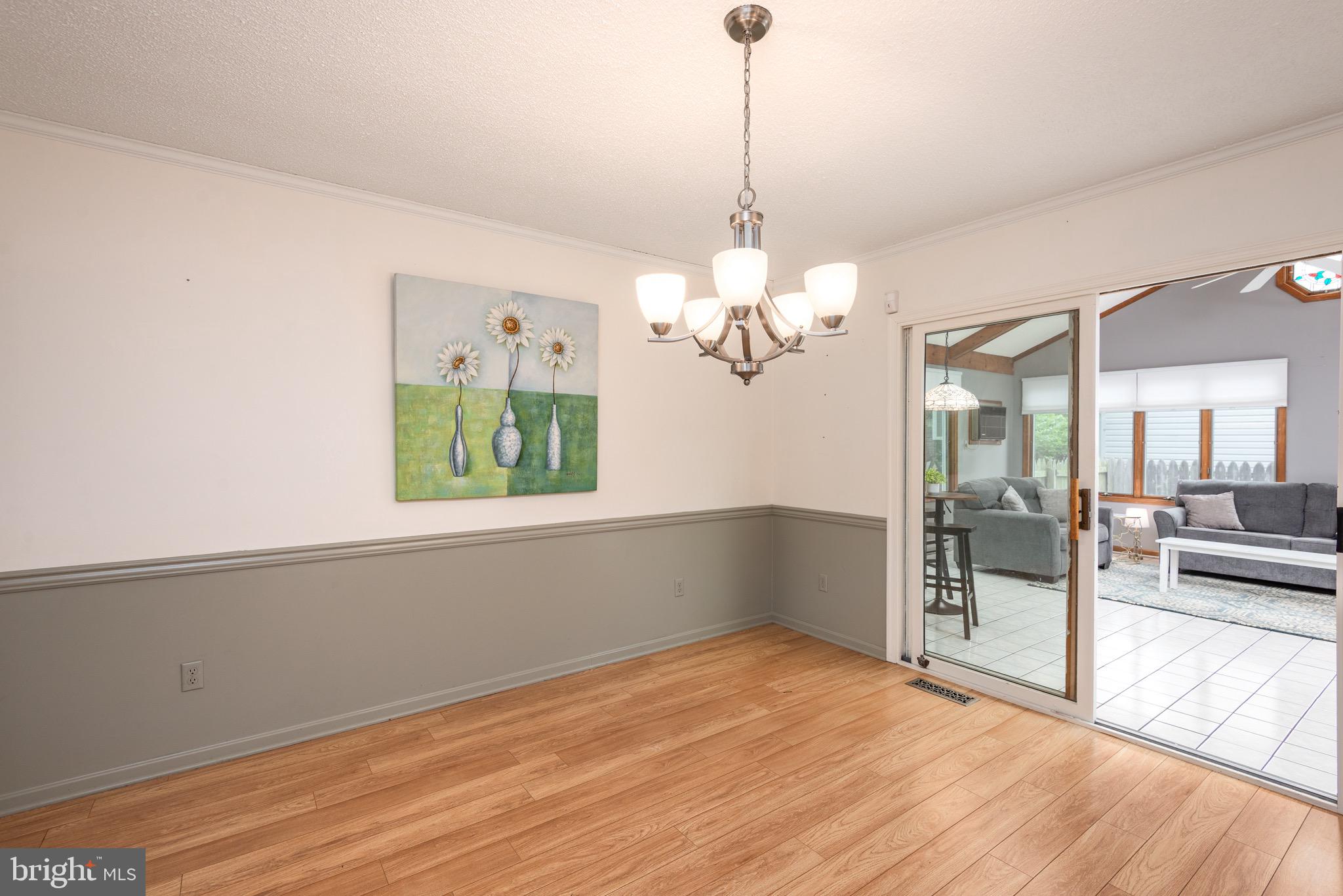 301 Spring Drive Easton, MD 21601 - Photo 12 of 32 a view of a livingroom with a chandelier wooden floor and a chandelier