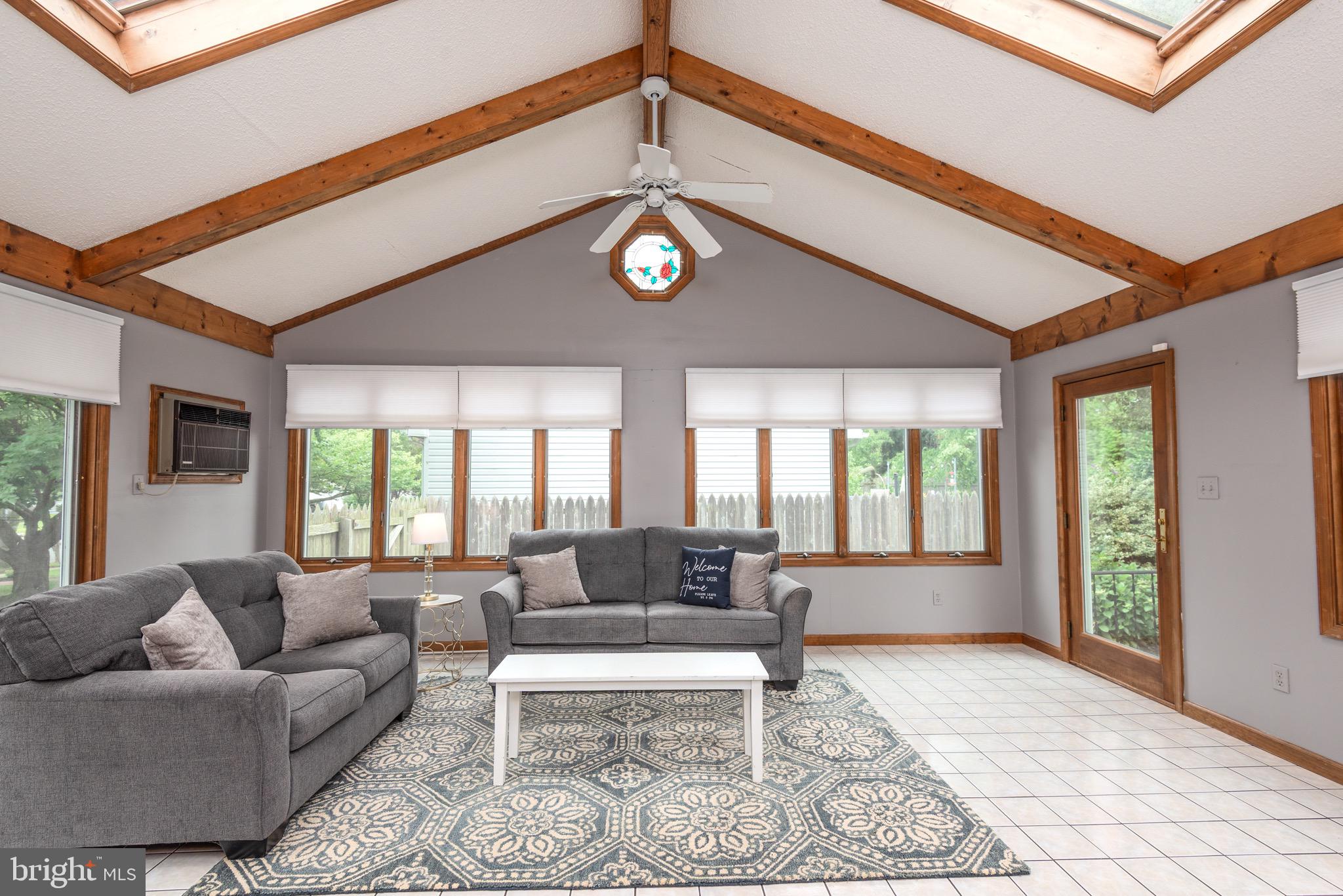 301 Spring Drive Easton, MD 21601 - Photo 13 of 32 a living room with furniture ceiling fan and a rug