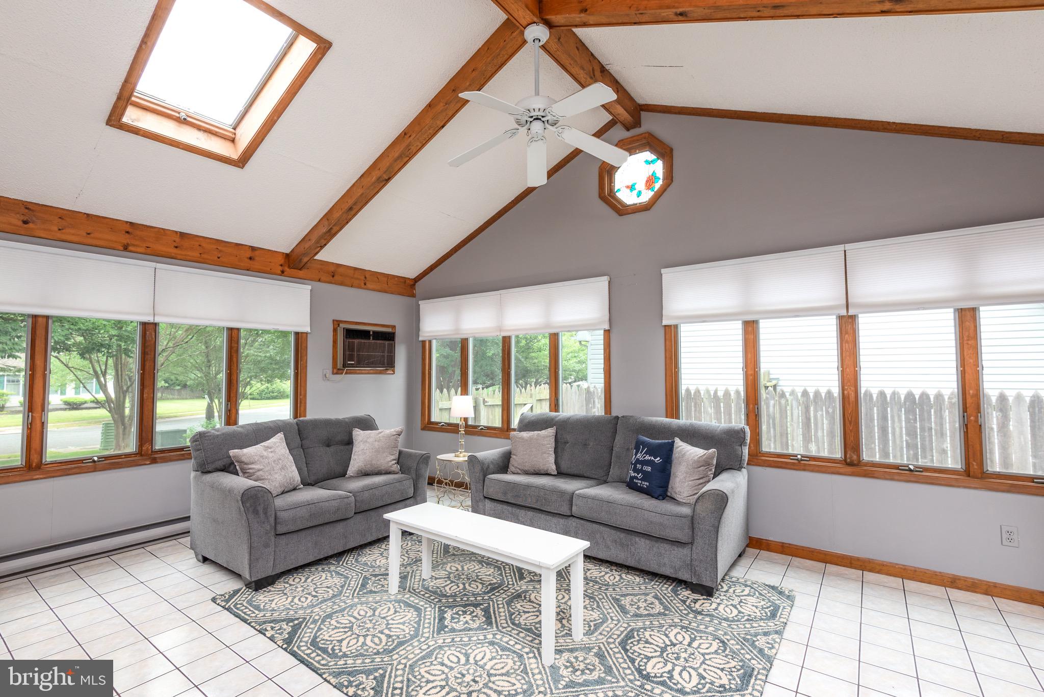 301 Spring Drive Easton, MD 21601 - Photo 16 of 32 a living room with furniture a large window and a table