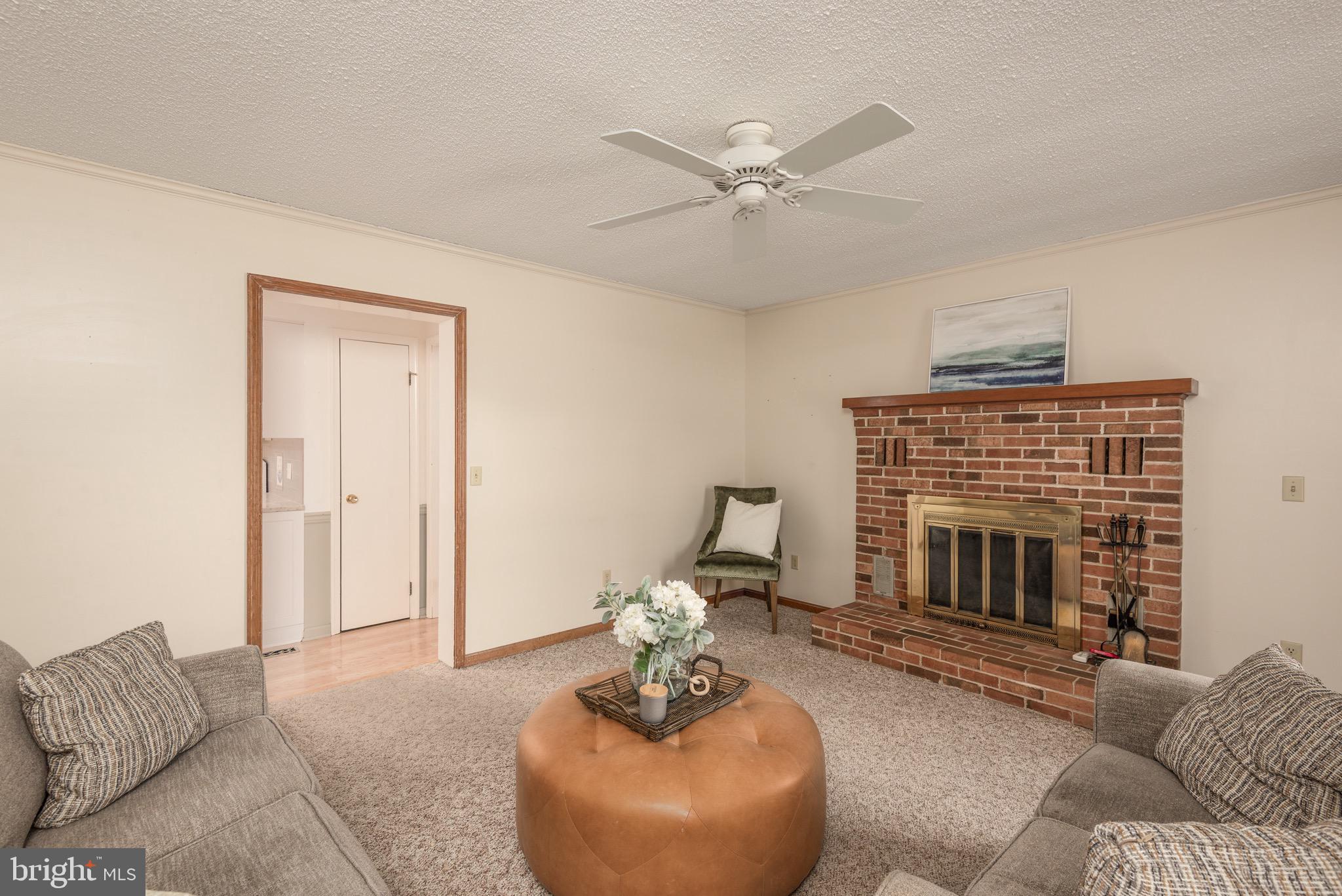 301 Spring Drive Easton, MD 21601 - Photo 18 of 32 a living room with furniture and a fireplace