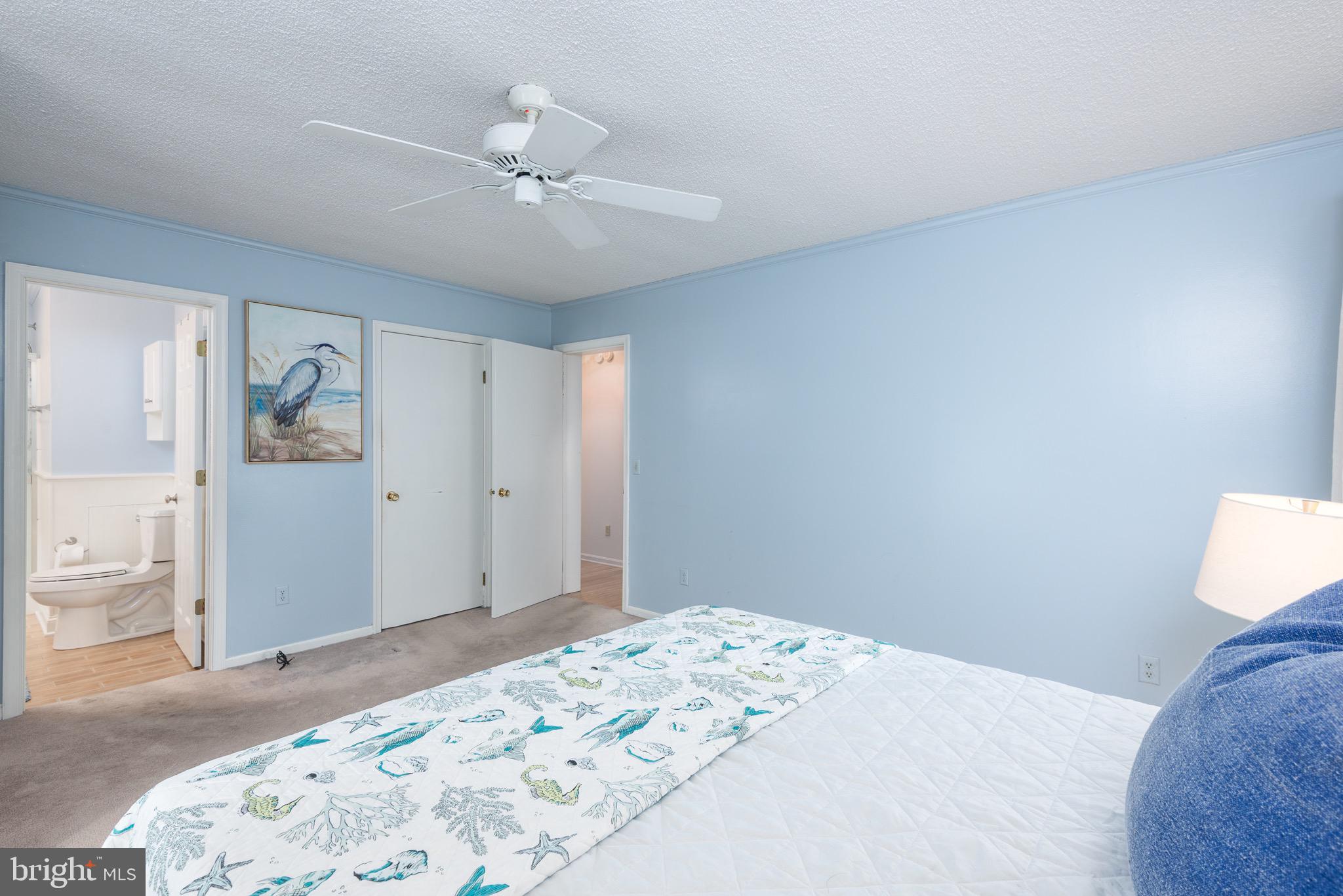 301 Spring Drive Easton, MD 21601 - Photo 23 of 32 a bedroom with a large bed and a chandelier