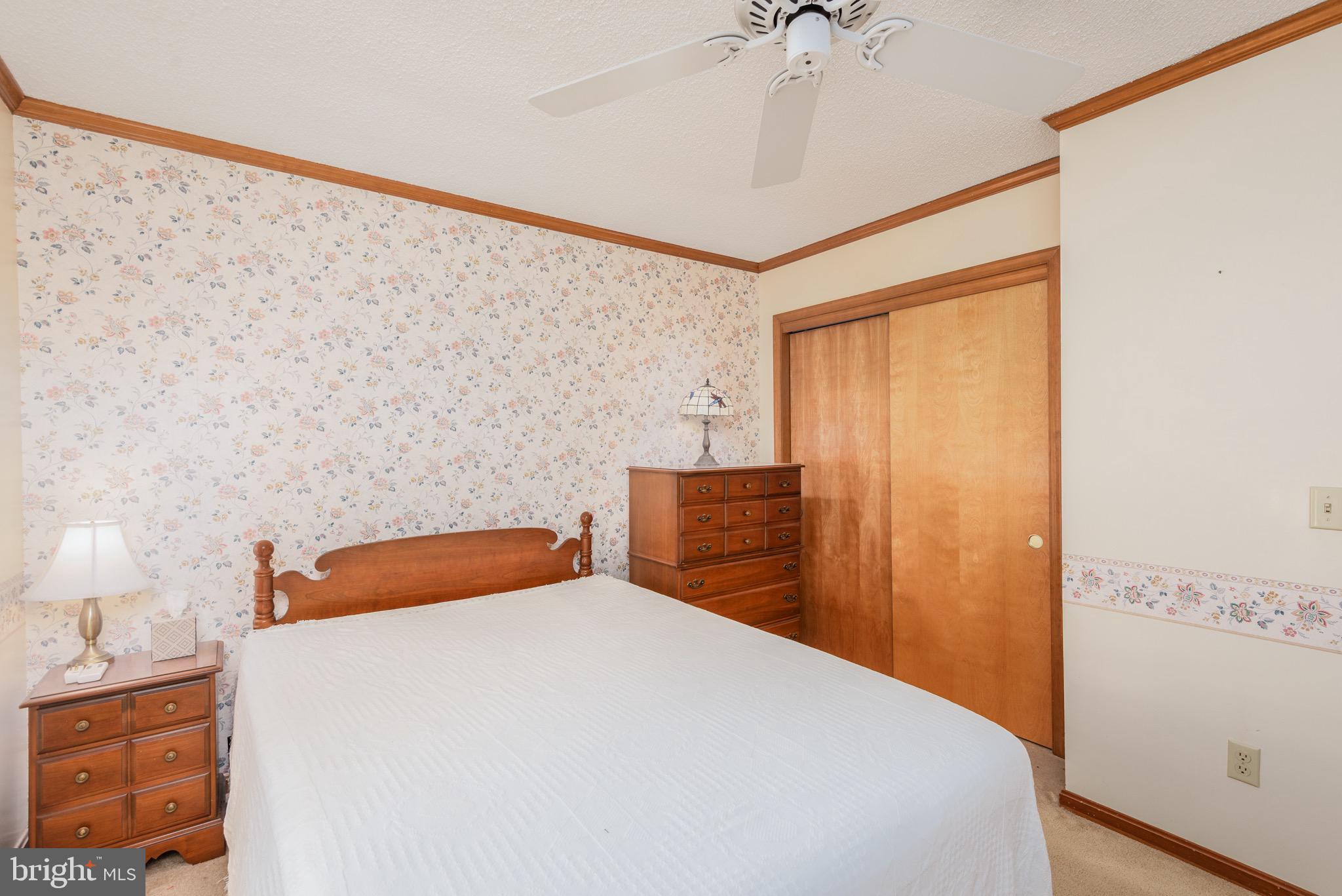 301 Spring Drive Easton, MD 21601 - Photo 25 of 32 a bedroom with a bed and a chandelier fan