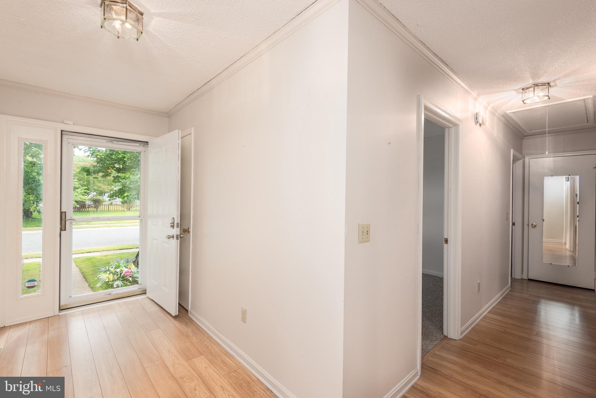 301 Spring Drive Easton, MD 21601 - Photo 6 of 32 a view of hallway with a large window and wooden floor