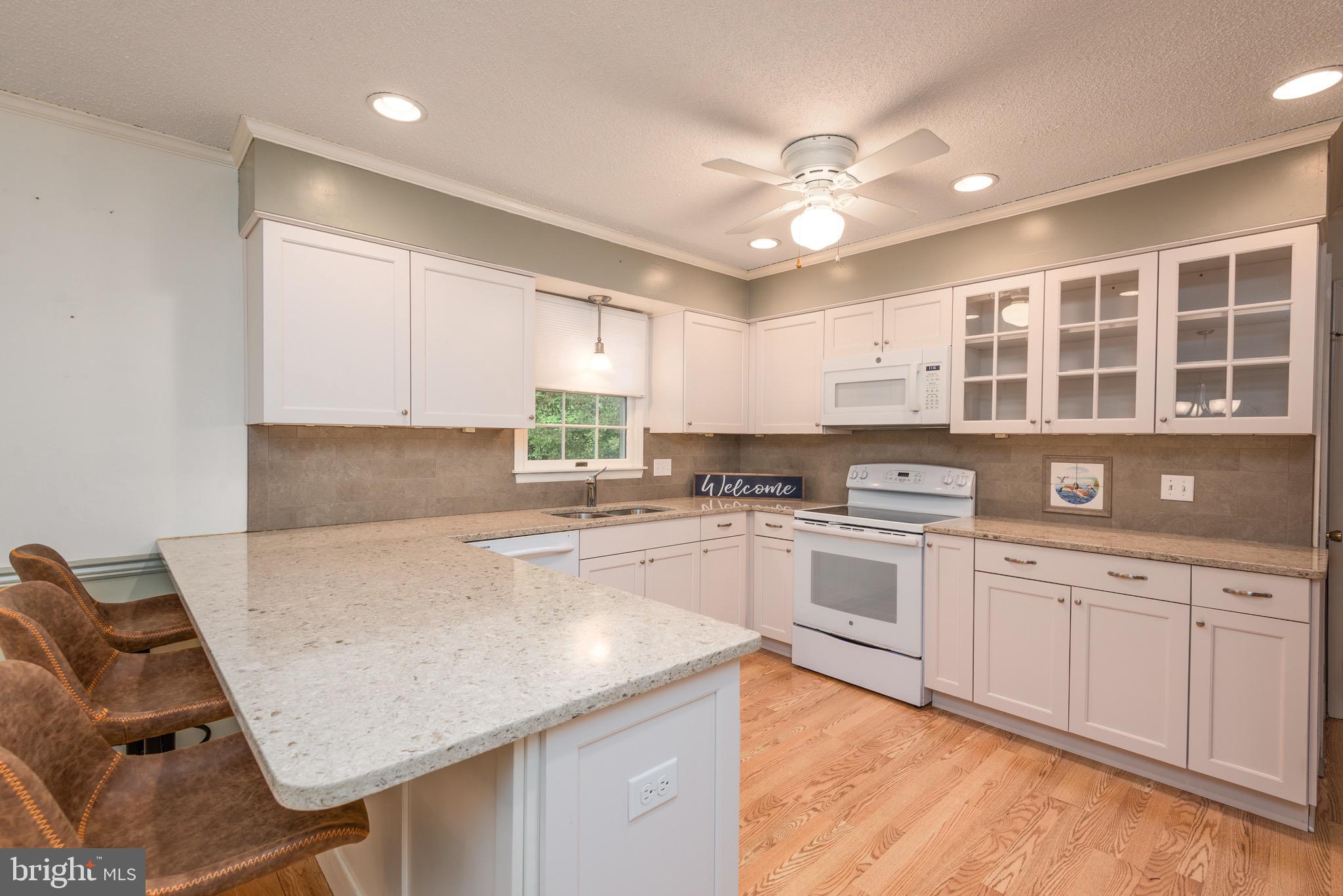 301 Spring Drive Easton, MD 21601 - Photo 8 of 32 a kitchen with a table chairs sink and cabinets