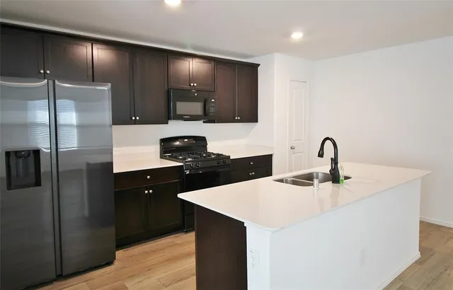 a kitchen with a sink and cabinets