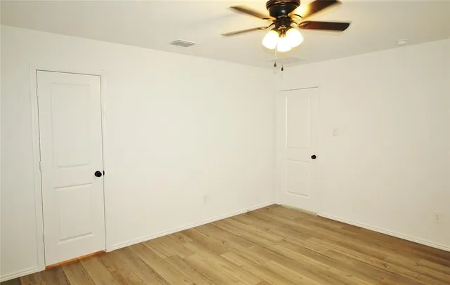 a view of a room with a ceiling fan