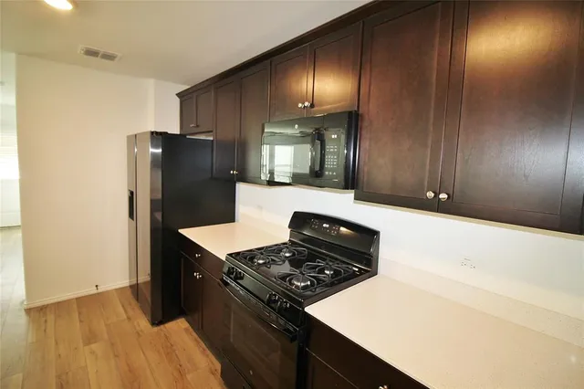 a kitchen with a stove and a refrigerator