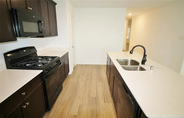 a kitchen with a sink and a stove top oven
