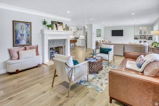 1350 Canyon Park Road Bountiful, UT 84010 - Photo 6 of 38 Bright living space featuring wood-finish flooring and a white fireplace with a mosaic tile surround