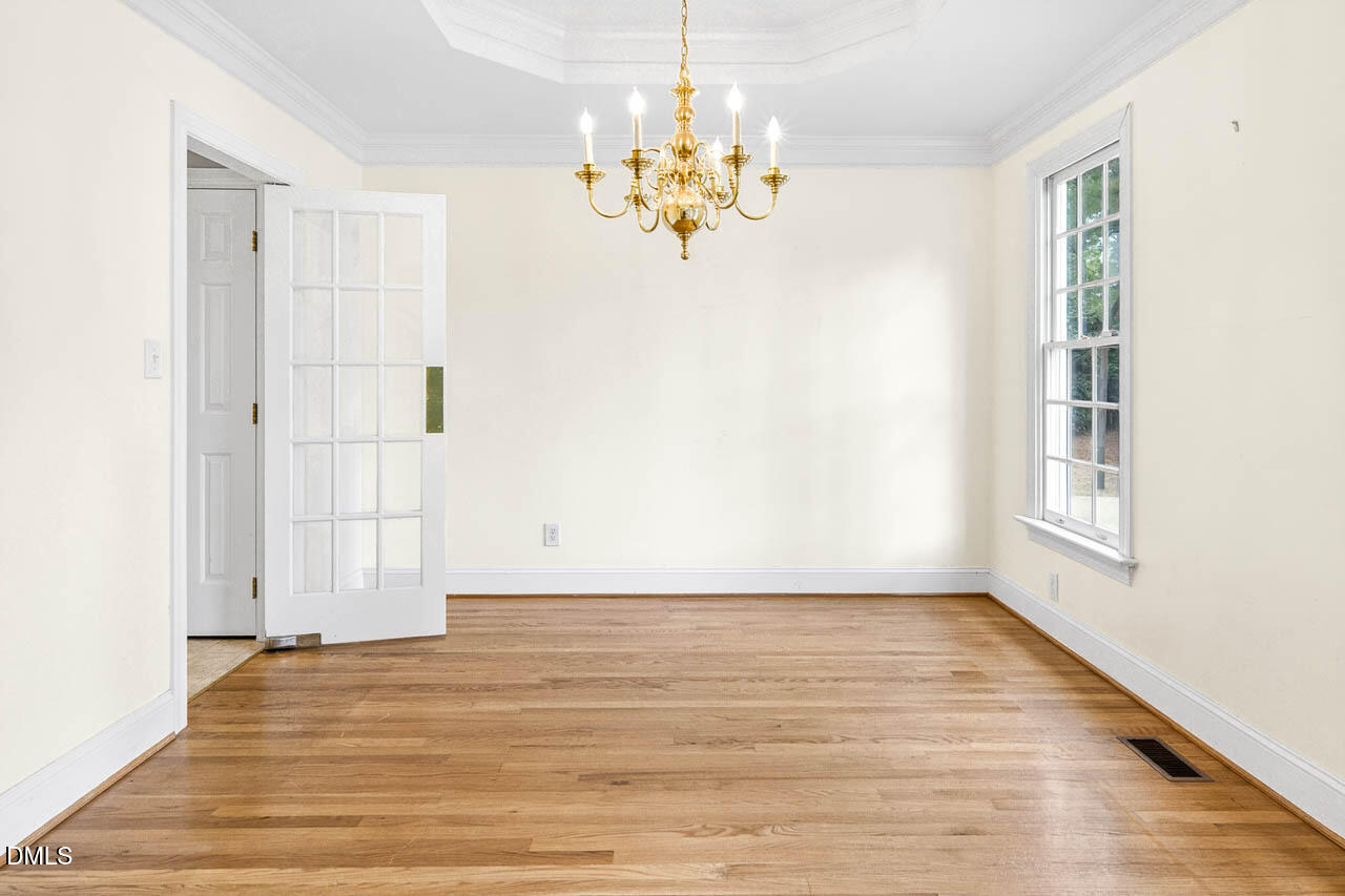 2209 Lodestar Drive Raleigh, NC 27615 - Photo 20 of 50 a view of a room with wooden floor and chandelier
