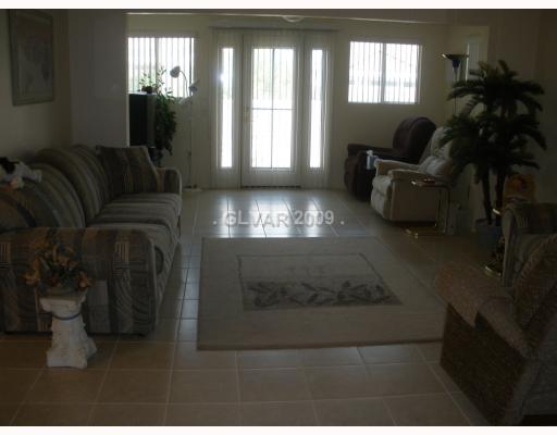 8720 Pennystone Avenue Las Vegas, NV 89134 - Photo 4 of 15 Living Room. Expanded Living Room with Media Center going to rear patio.