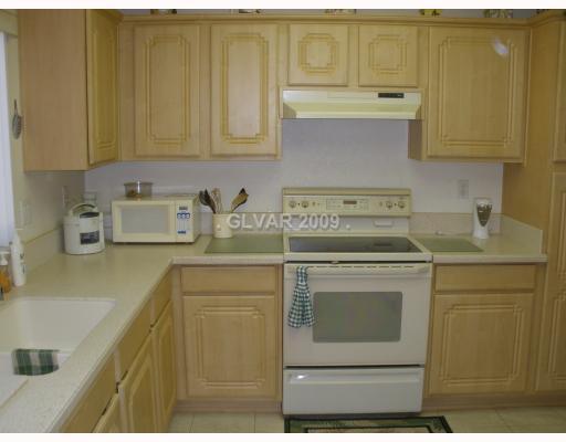 8720 Pennystone Avenue Las Vegas, NV 89134 - Photo 6 of 15 Kitchen. Custom Cabinets with Avonite Counter Tops (Attachment)