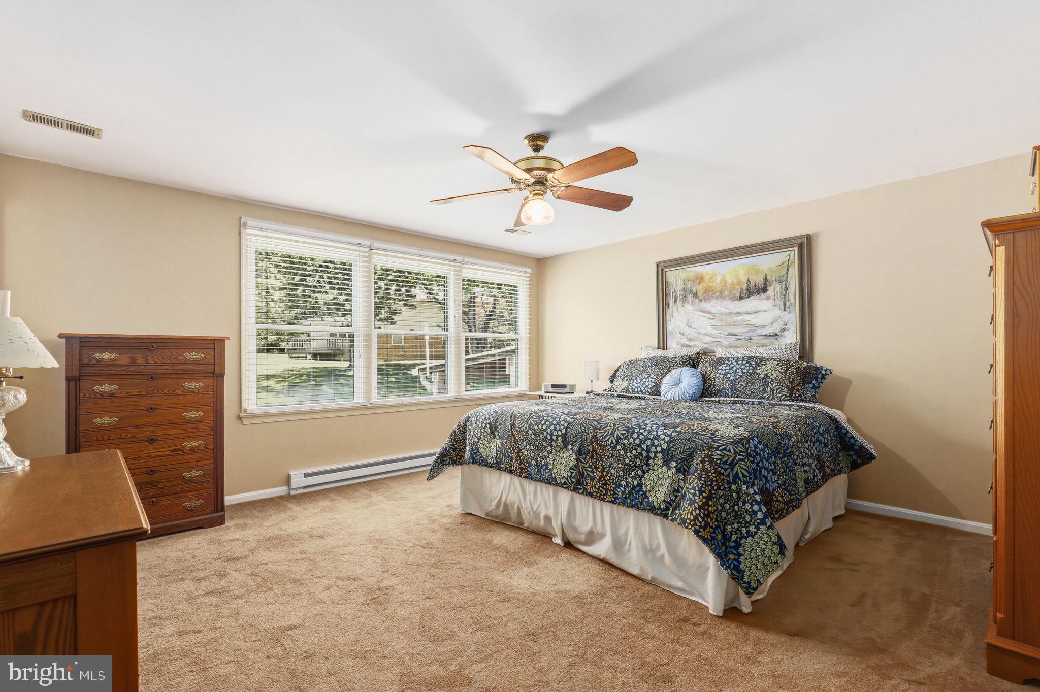 6336 Boyers Mill Road New Market, MD 21774 - Photo 20 of 49 a spacious bedroom with a bed and dresser with wooden floor