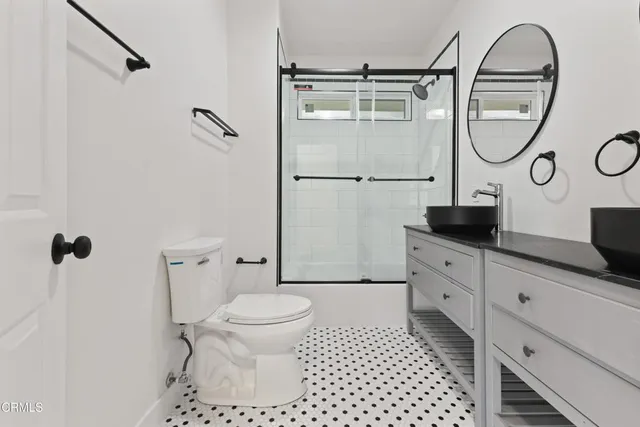 a bathroom with a toilet a sink and a mirror
