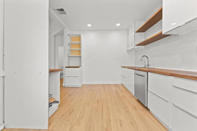 a hallway with a sink and a mirror