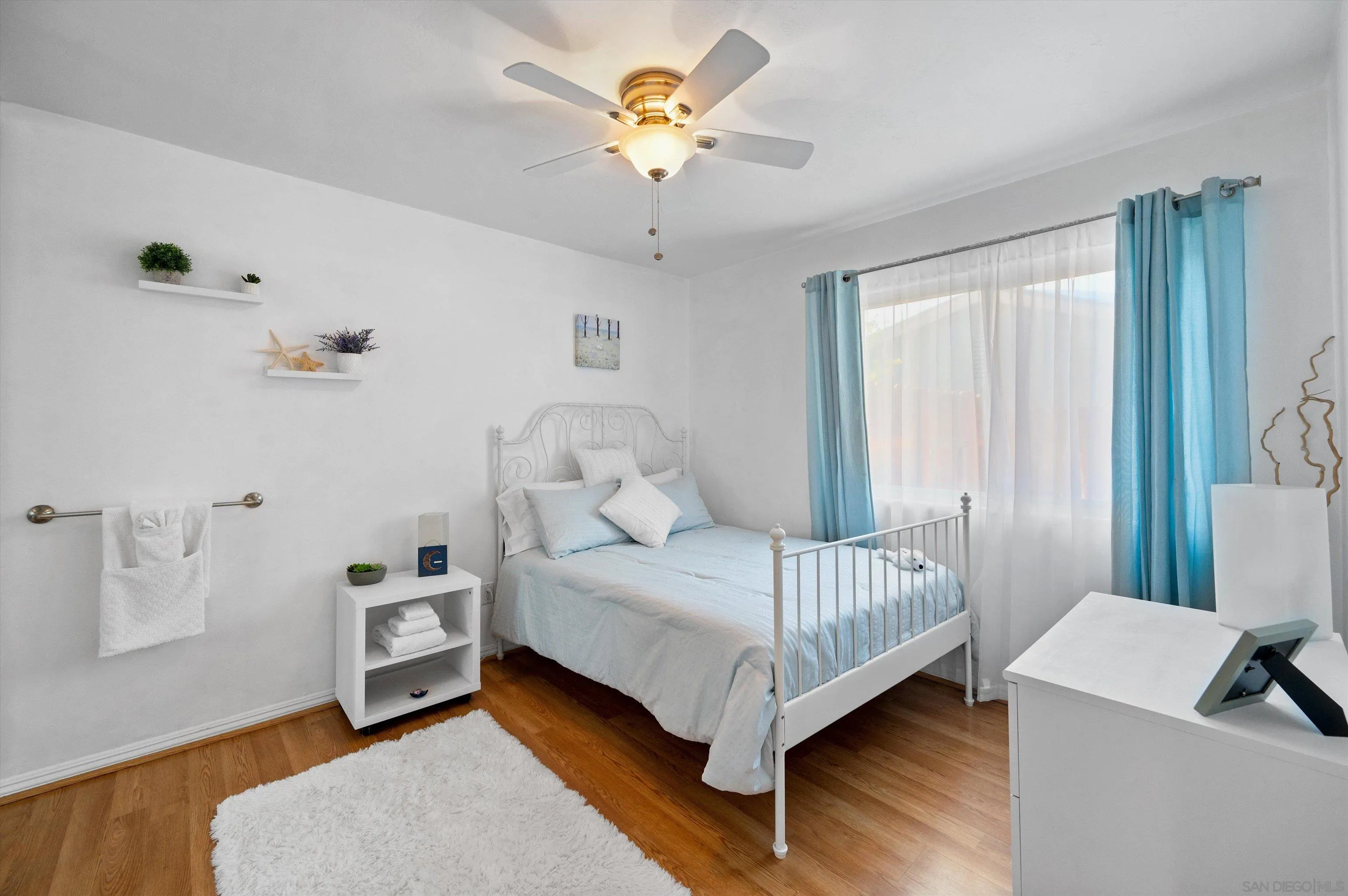 2537 Buena Rosa Fallbrook, CA 92028 - Photo 11 of 20 a bedroom with a bed and a chandelier