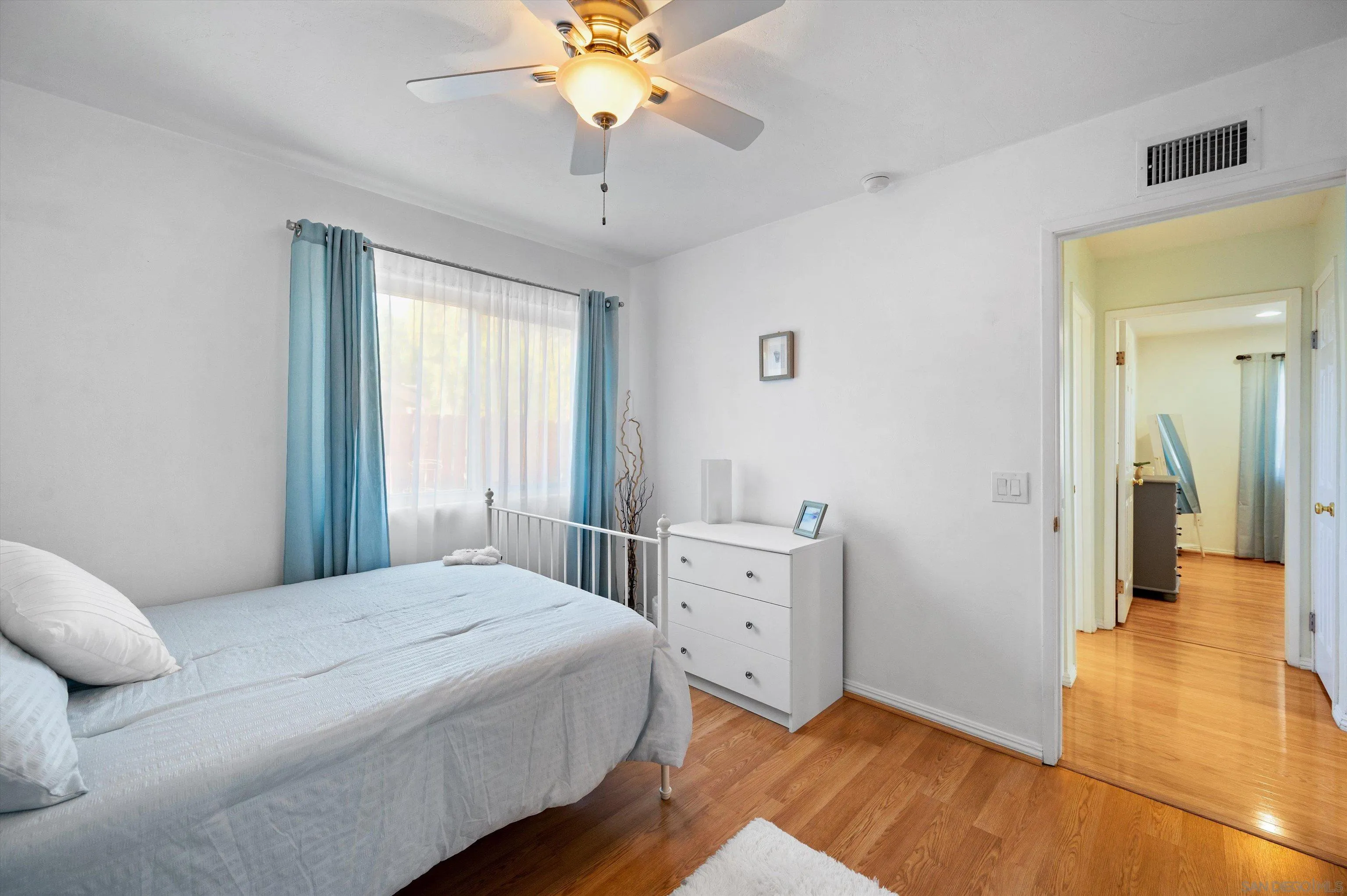 2537 Buena Rosa Fallbrook, CA 92028 - Photo 12 of 20 a bedroom with a bed and a chandelier