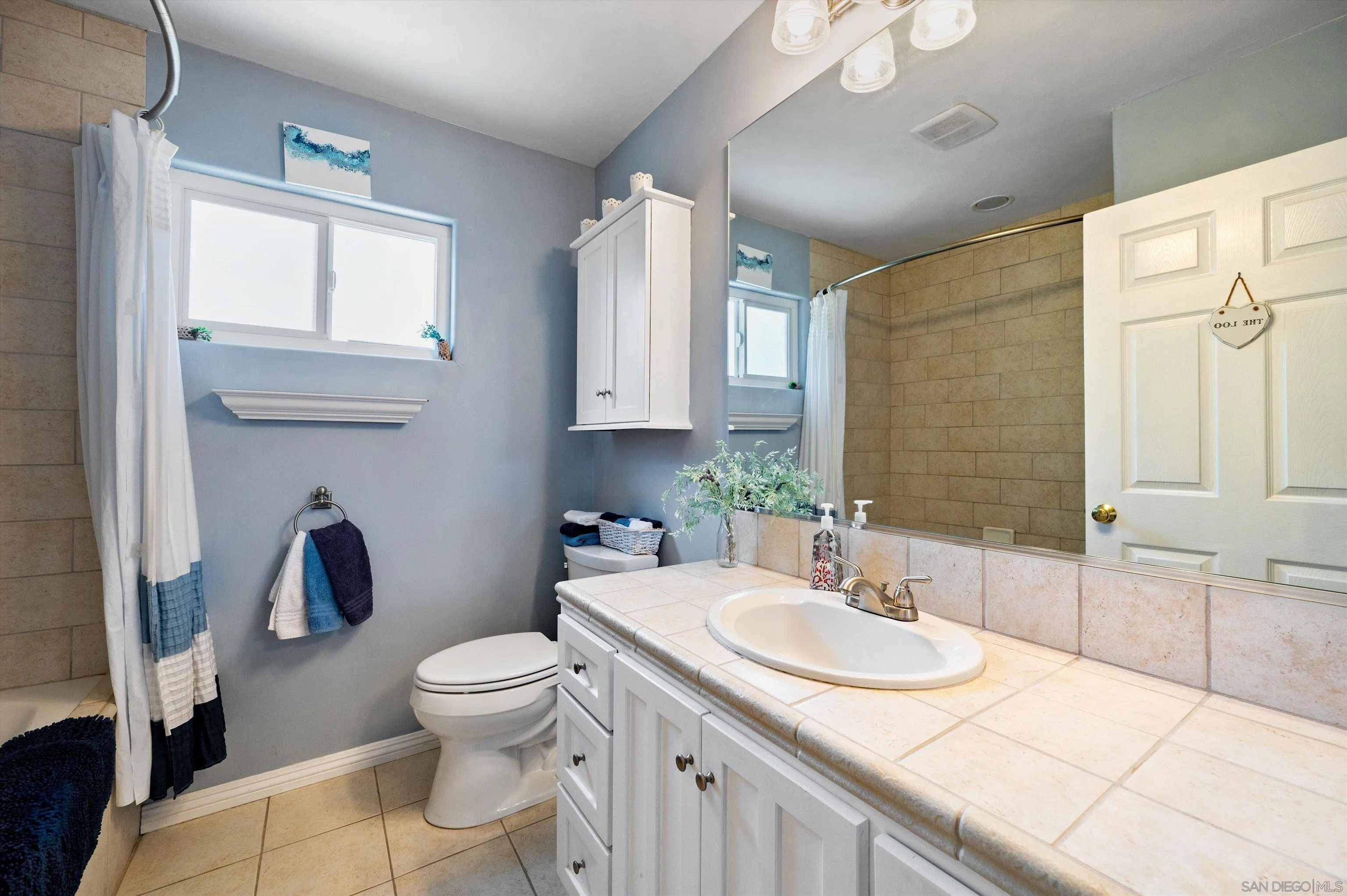 2537 Buena Rosa Fallbrook, CA 92028 - Photo 13 of 20 a bathroom with a granite countertop sink a toilet and a mirror