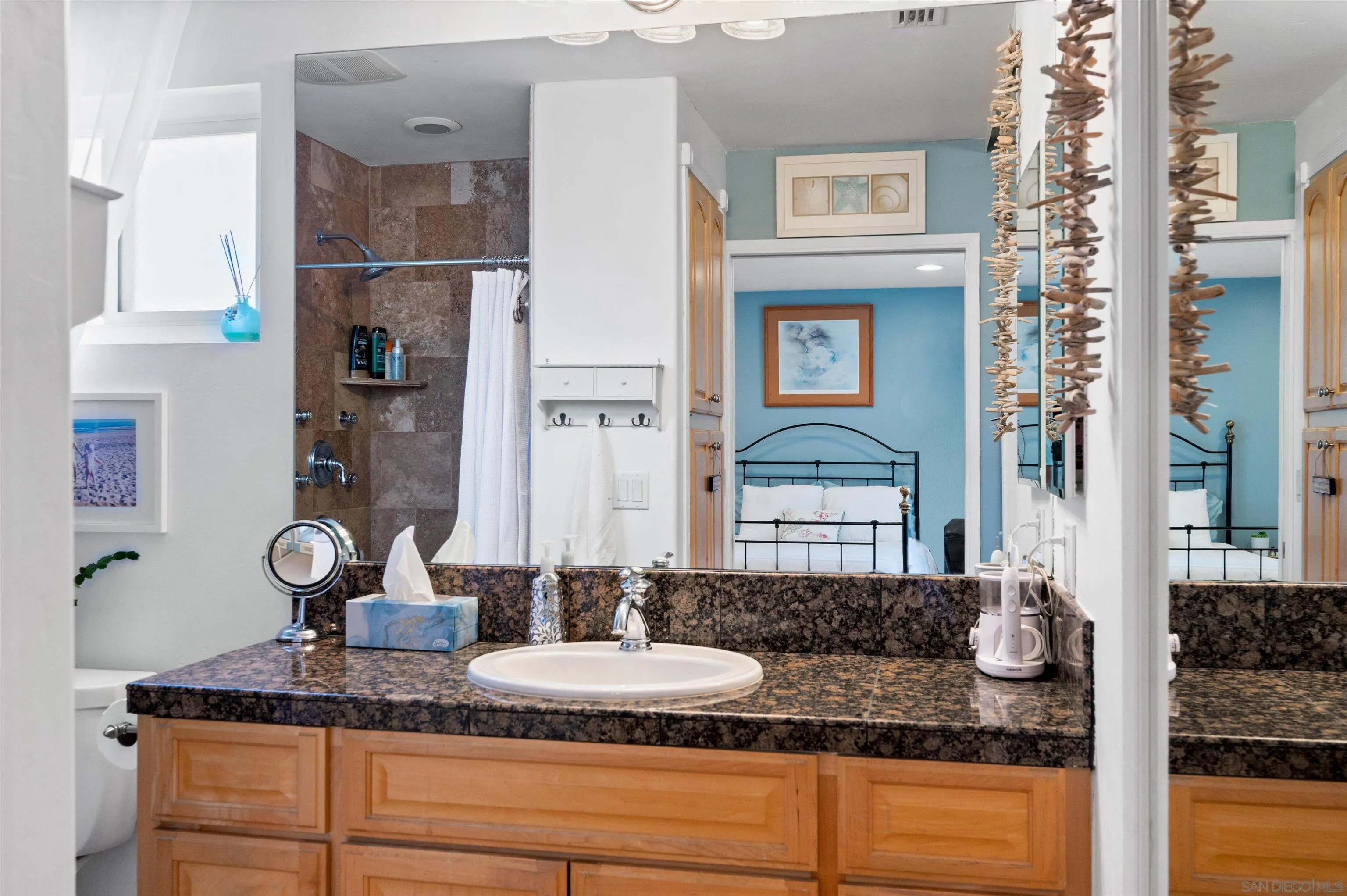 2537 Buena Rosa Fallbrook, CA 92028 - Photo 16 of 20 a bathroom with granite countertop a sink and a mirror