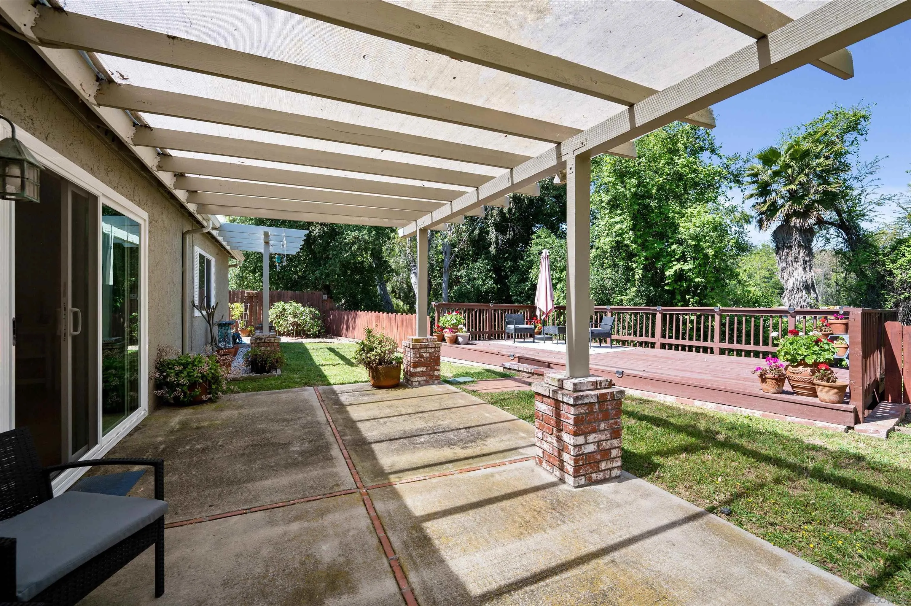 2537 Buena Rosa Fallbrook, CA 92028 - Photo 19 of 20 a view of a patio with table and chairs potted plants with floor to ceiling window and potted plants
