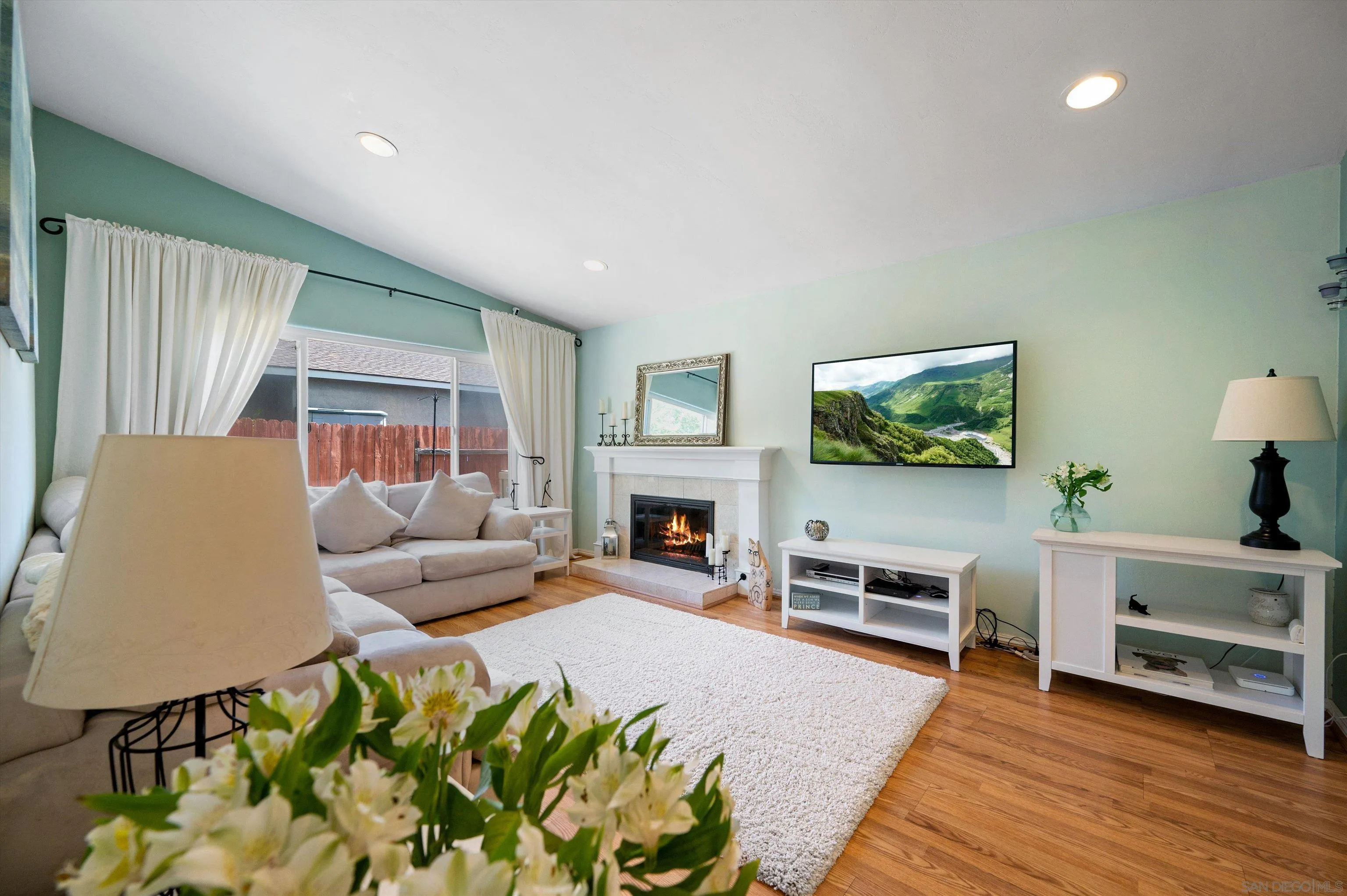 2537 Buena Rosa Fallbrook, CA 92028 - Photo 3 of 20 a living room with furniture a fireplace and a flat screen tv