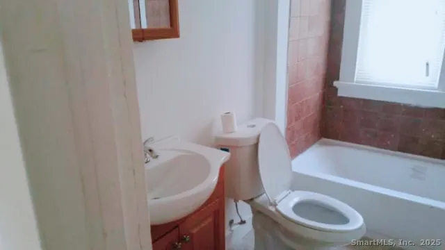 a bathroom with a sink a toilet and bathtub
