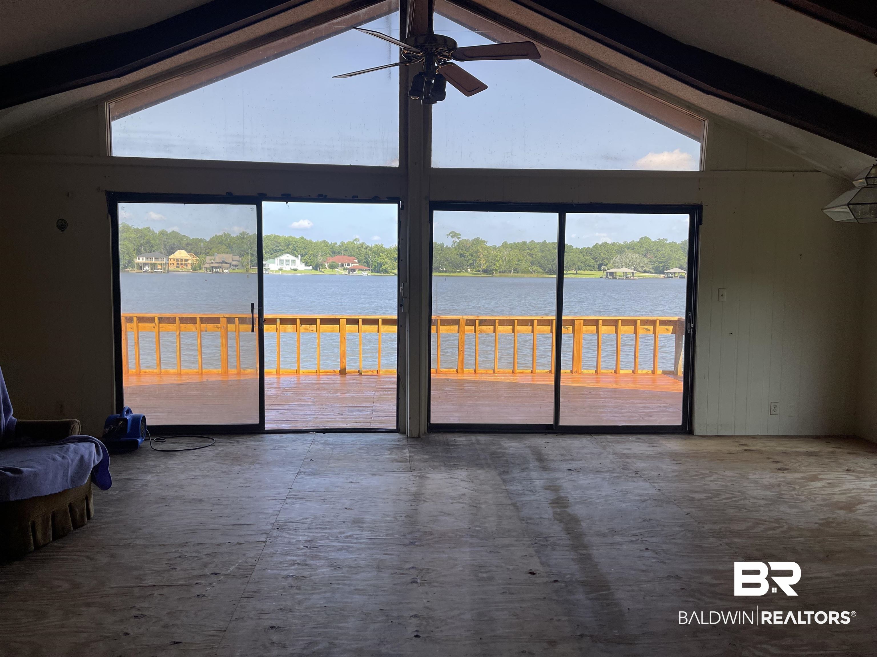3074 Riverside Drive West Mobile, AL 36605 - Photo 5 of 15 Unfurnished living room featuring beam ceiling, plenty of natural light, and high vaulted ceiling