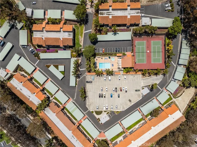 an aerial view of a building with parking