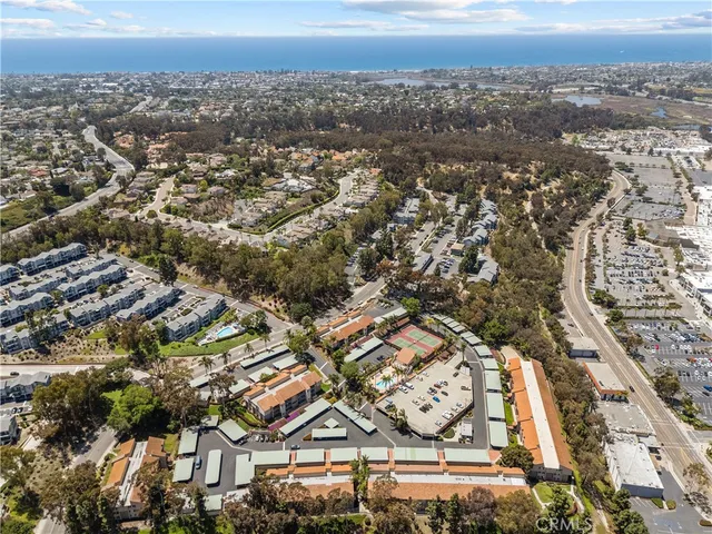 an aerial view of residential houses with city view