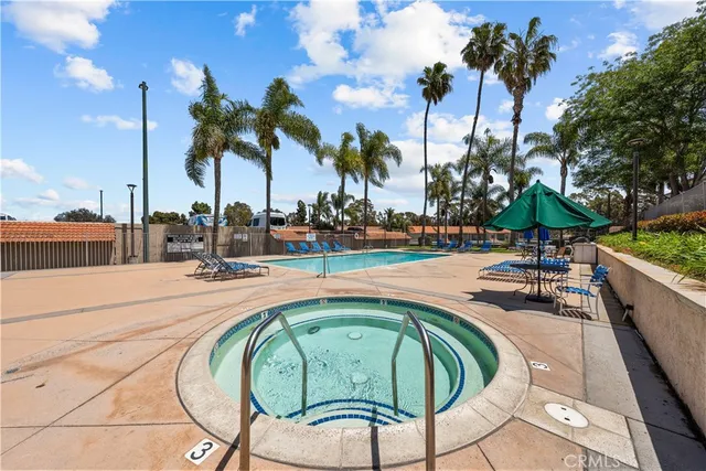 a swimming pool with outdoor seating and yard